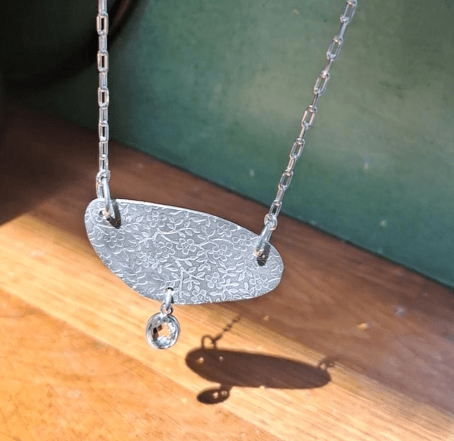 Floral silver & quartz pendant